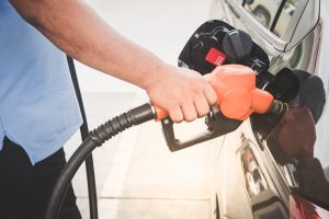 A person refueling their car