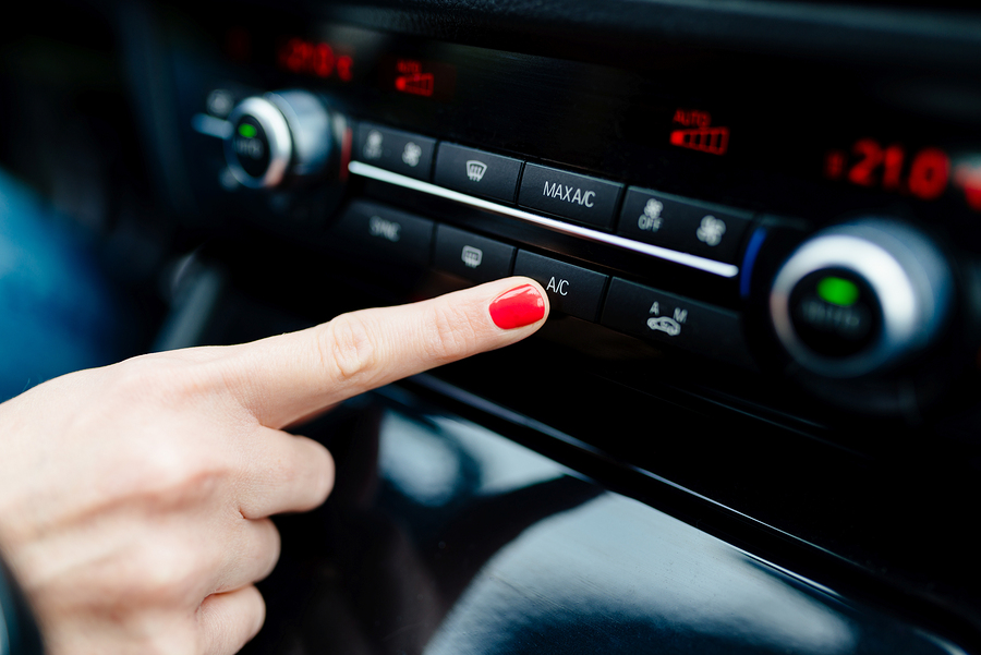 A woman turning on her Air Con