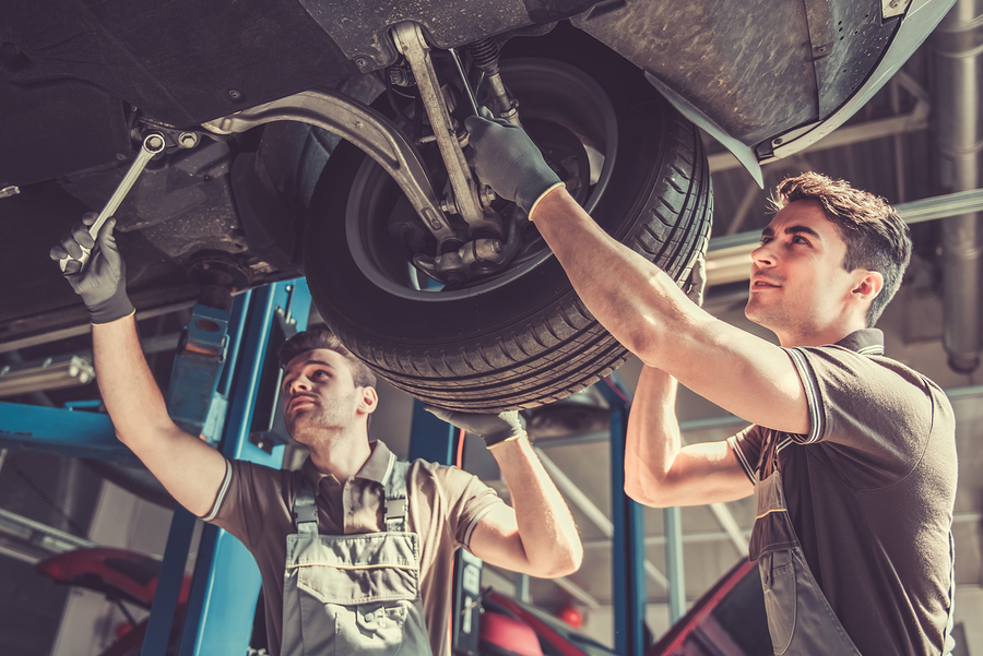 2 mechanics working on a car