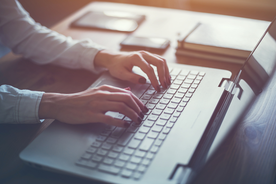 A woman blogging on a laptop